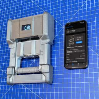 DEXDIA GX alongside an iPhone with the GripMeter app open and connected to the DEXDIA GX device.