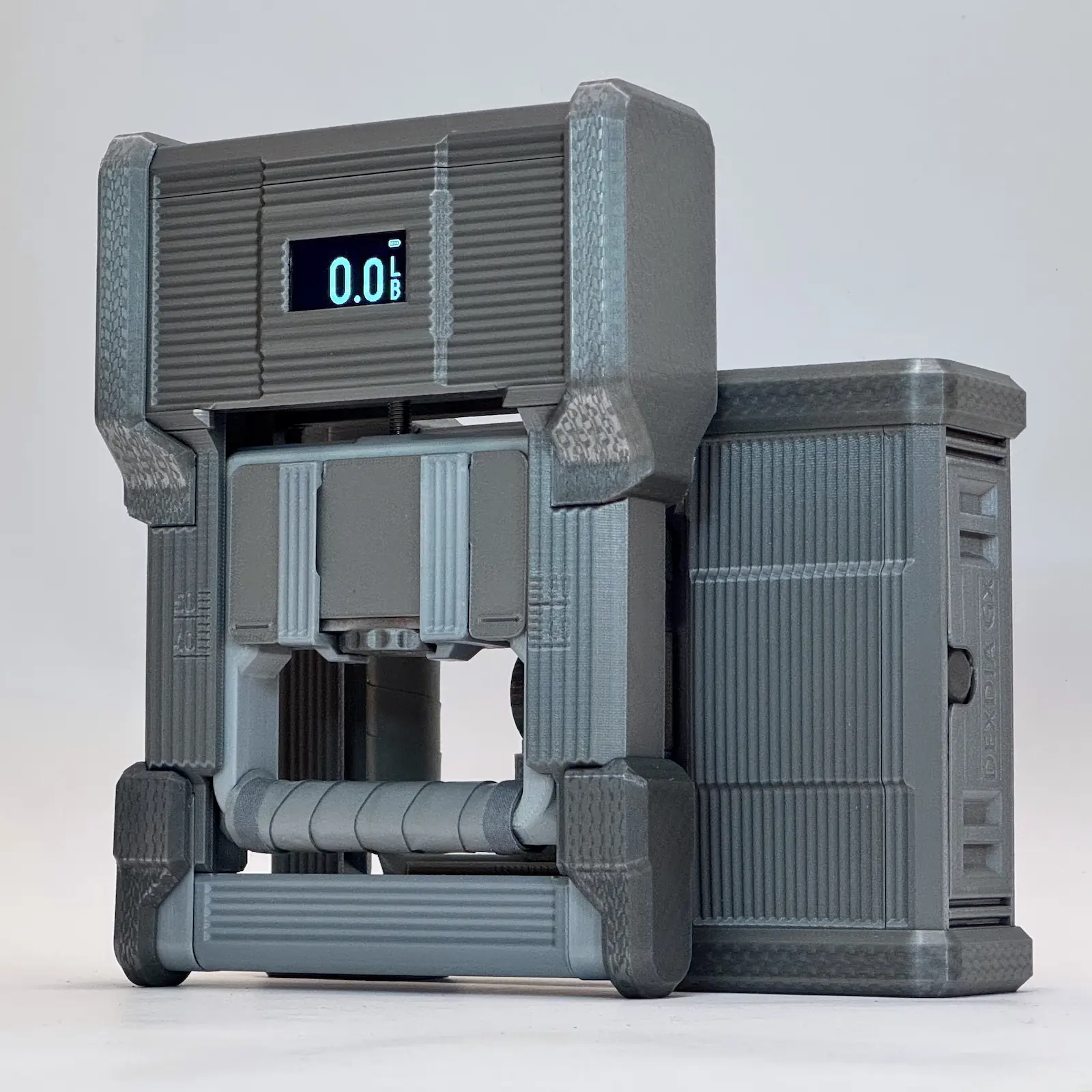 Two Grip Strength Dynamometer DEXDIA GX devices. One positioned upright, the other lying on its side.